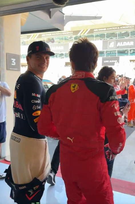 Max Verstappen after putting a Redbull sticker on Charle's shoulder.